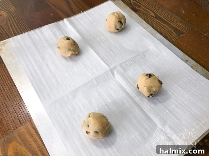Ghoulish Gaze Cookie Pops 2 Chocolate chip cookie dough with lollipop sticks on baking sheet