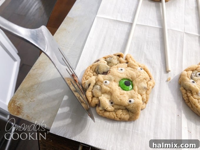 Ghoulish Gaze Cookie Pops 4 Rounding warm cookies with a spatula after baking