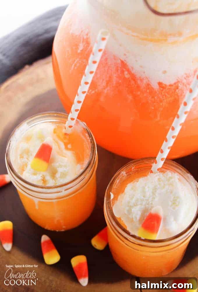 Candy Corn Elixir 3 overhead view of two mason jars holding candy corn punch