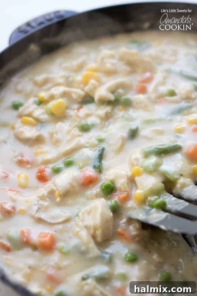 Chicken Pot Pie Tater Tot Casserole cooking on the stovetop