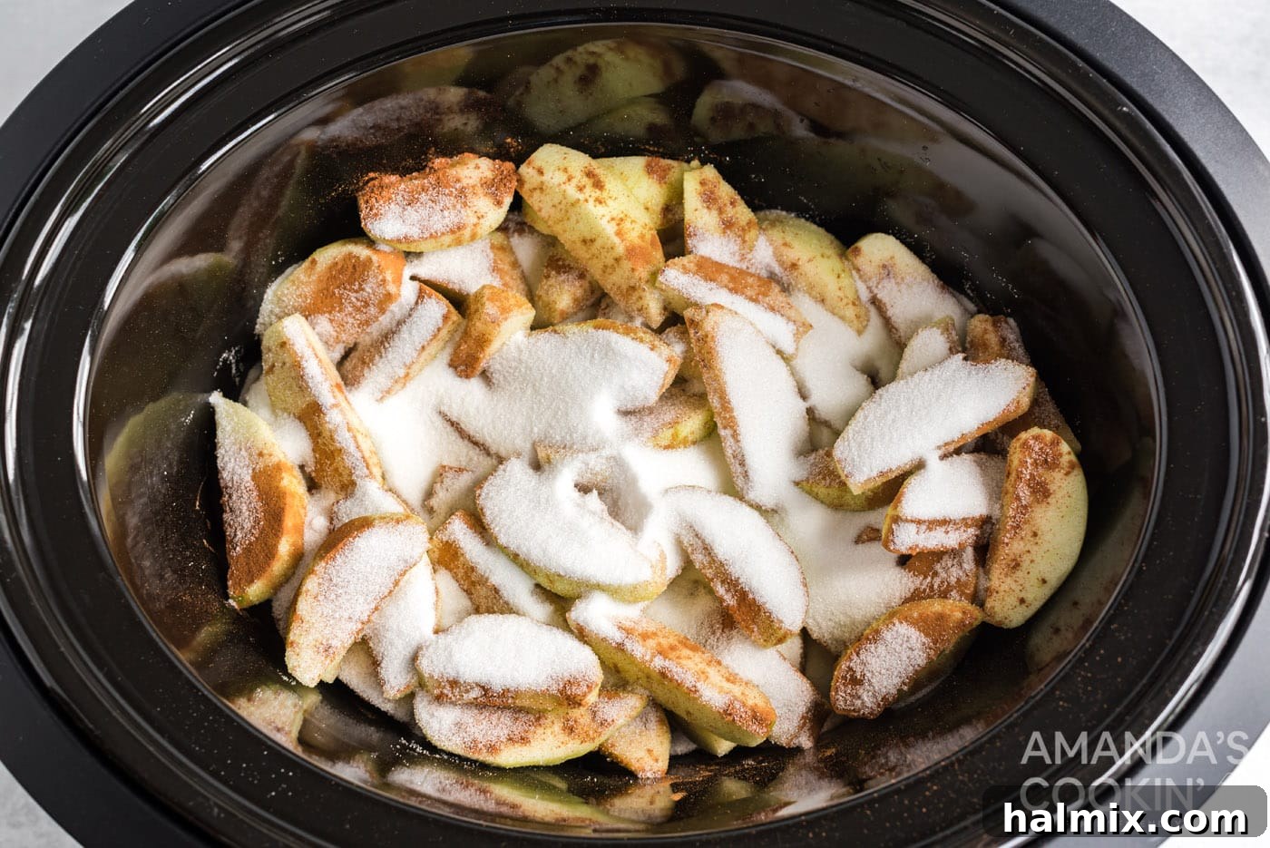 Slow-Cooked Apple Cinnamon Delight 6 sugar and cinnamon on apple slices in crockpot
