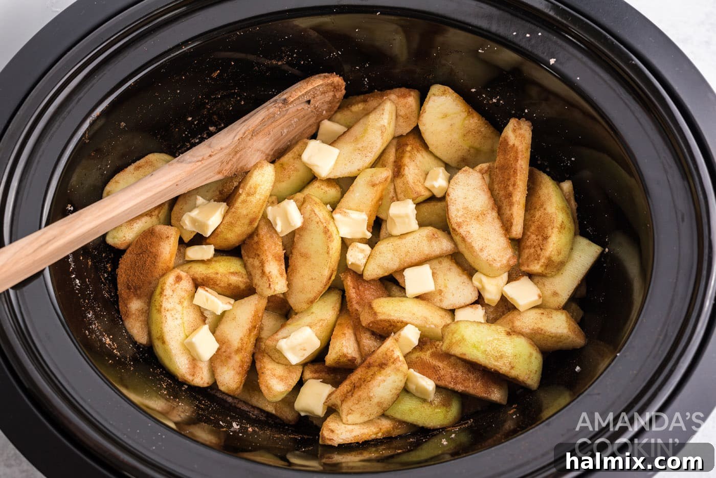 Slow-Cooked Apple Cinnamon Delight 7 butter on top of cinnamon sugar apples