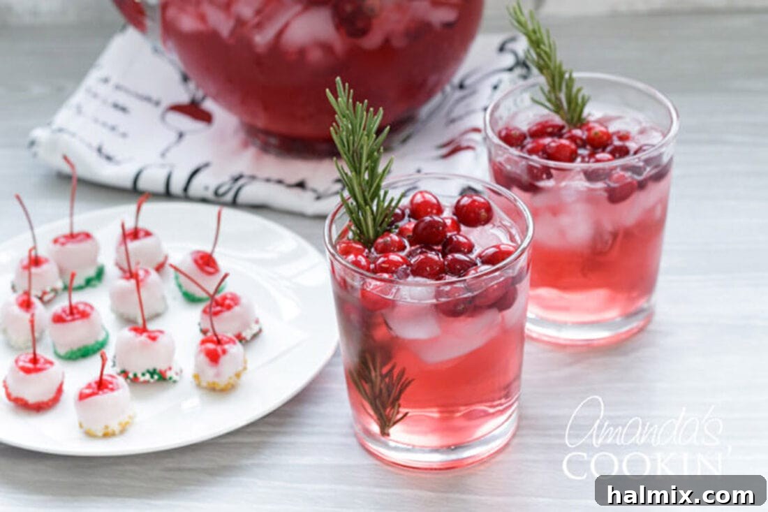Crimson Cranberry Cheer 3 glasses of cranberry holiday punch with spiked cherries on a festive plate