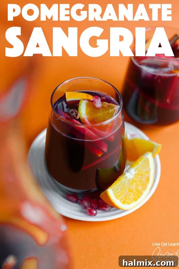This Pomegranate Sangria is bursting with fresh, seasonal fruit and is so easy to make. Perfect for holiday get togethers! #pomegranate #sangria #cocktail #falldrinks #christmas #thanksgiving #thanksgivingdrinks #friendsgiving Pomegranate Sangria