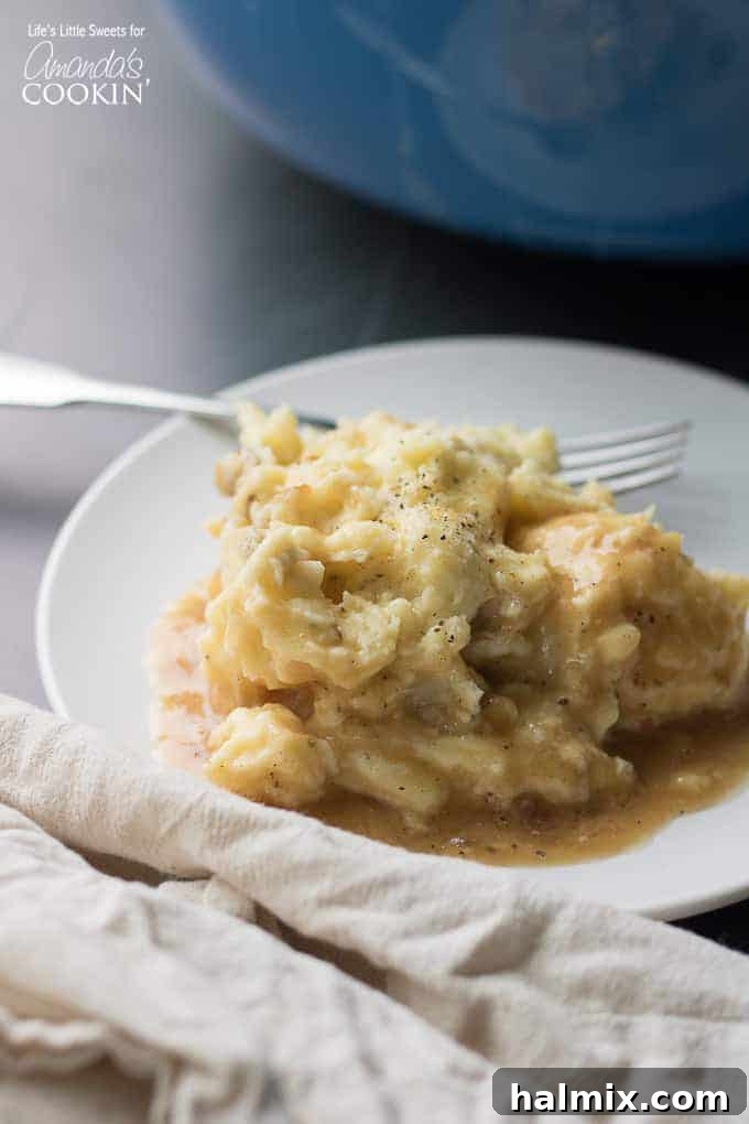 Creamy Traditional Mashed Potatoes Serving A serving of creamy traditional mashed potatoes on a white plate, ready to be enjoyed.