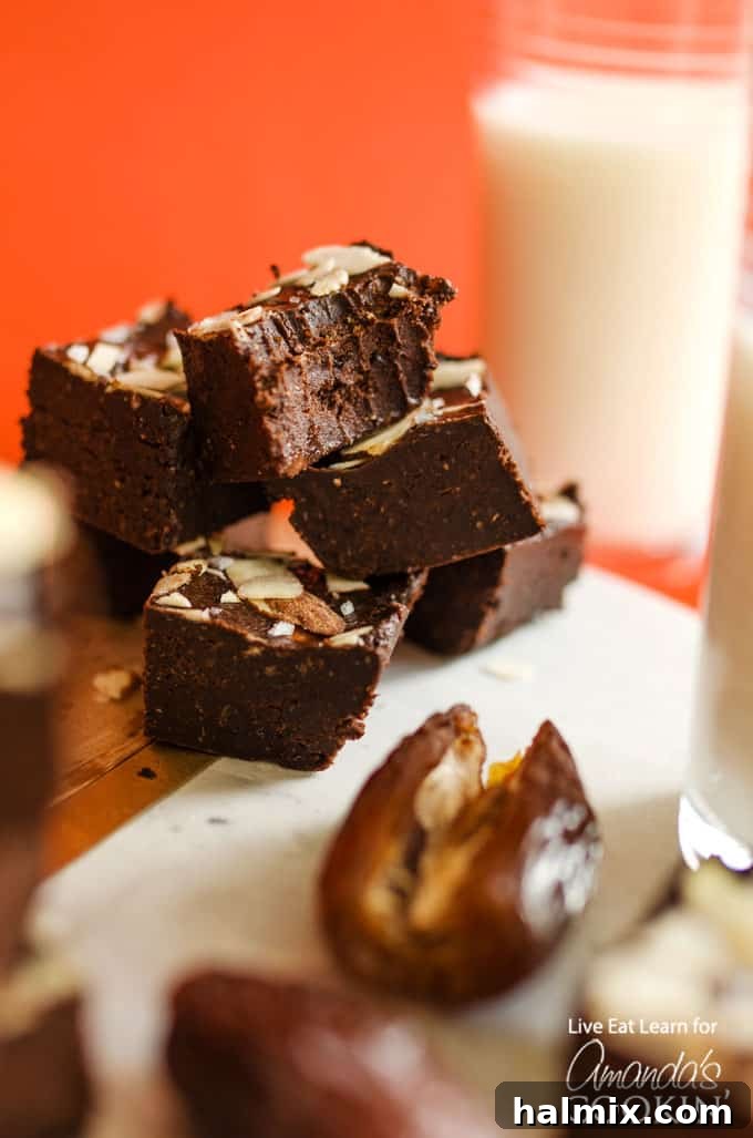 Stacked squares of rich, dark chocolate freezer fudge, showcasing its smooth texture and tempting appearance.