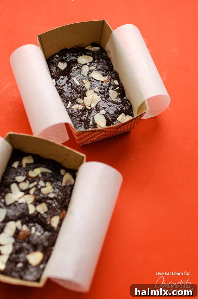 Two decorative boxes filled with squares of chocolate fudge, ready for gifting or serving.