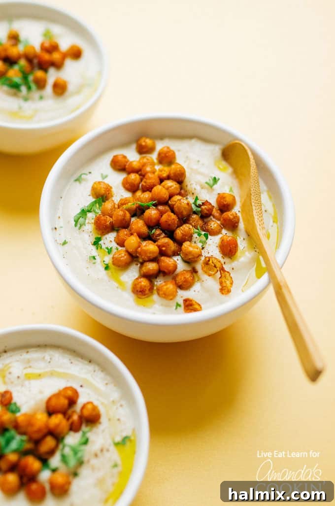 Crockpot creamy cauliflower soup in bowls with chickpeas