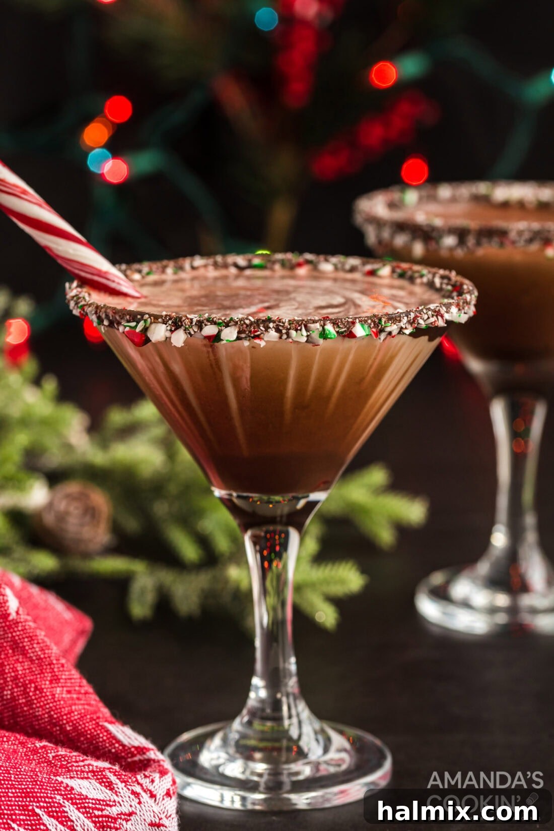 Two exquisite chocolate peppermint martinis adorned with candy cane rims, ready for a festive celebration.