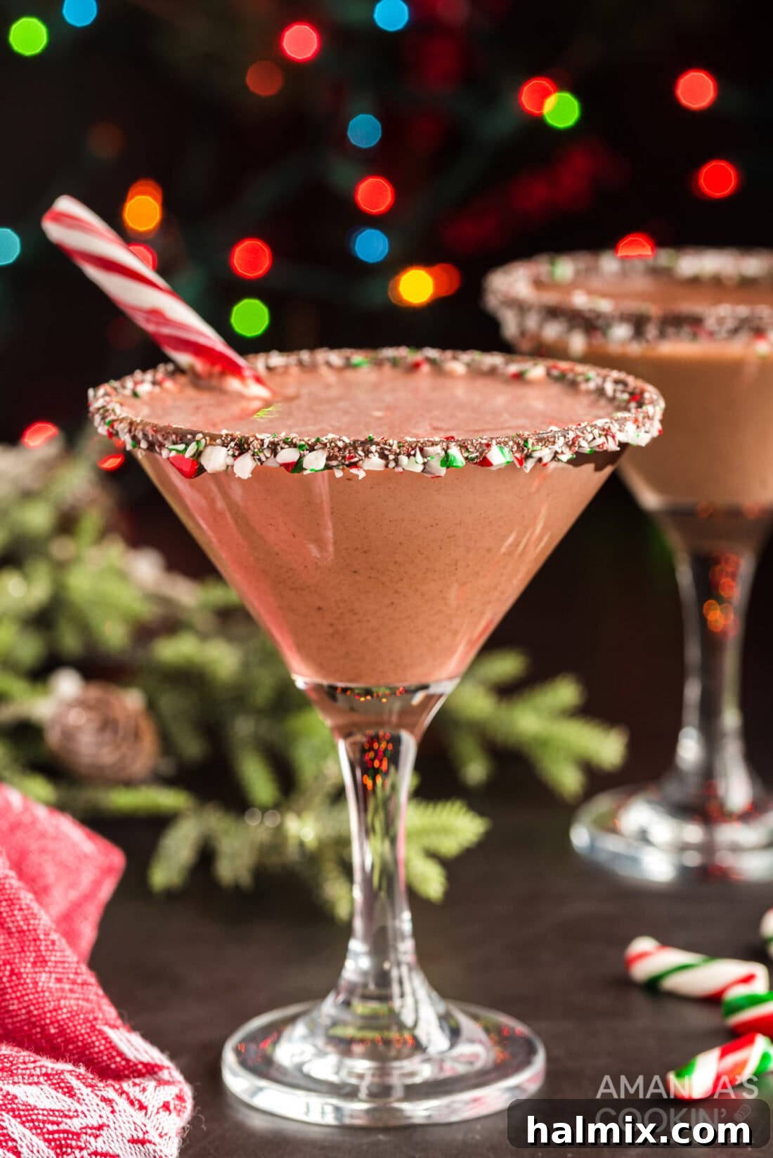 A chocolate peppermint martini elegantly garnished with a full candy cane, capturing the holiday spirit.