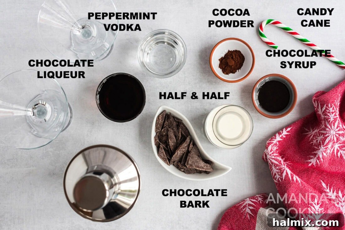 A curated display of ingredients for making a chocolate peppermint martini: candy canes, chocolate, various liqueurs, and cream.