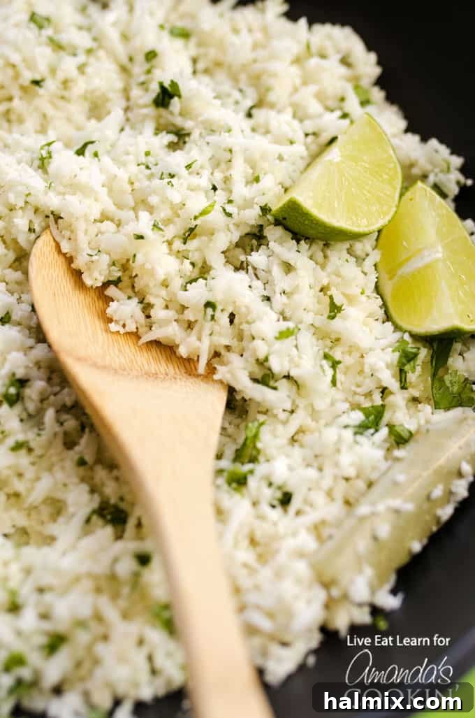 Copycat Cauliflower Chipotle Rice with vibrant lime wedges and fresh cilantro