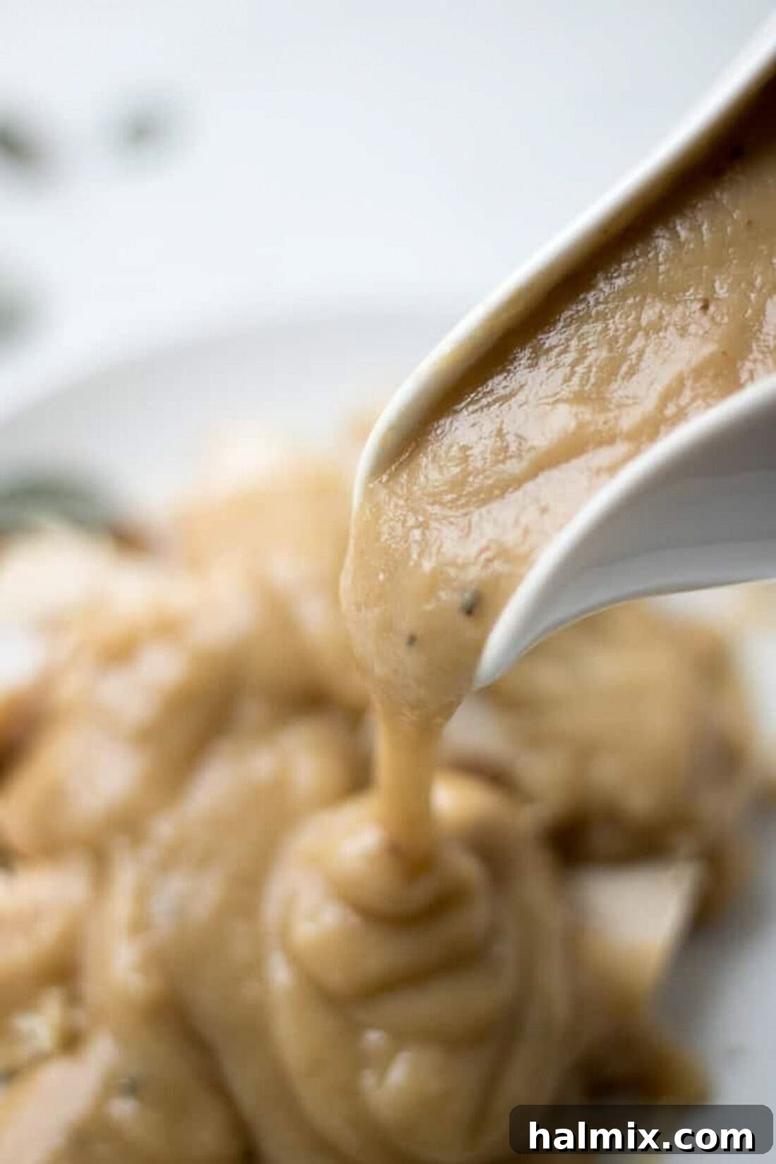 Homemade Turkey Gravy pouring out of a gravy boat