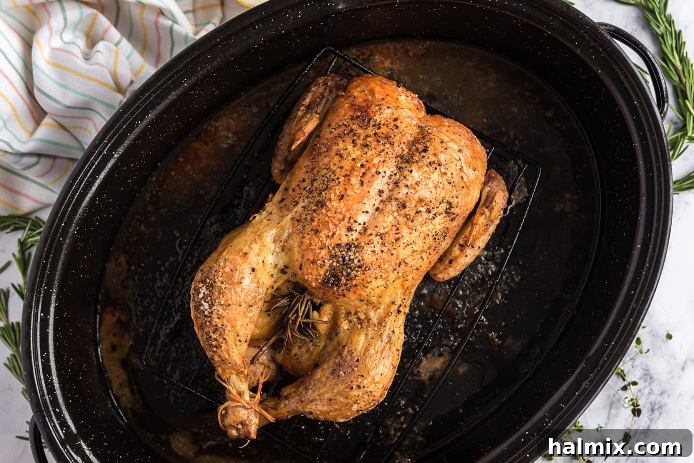 Golden Roasted Chicken 9 An overhead shot of a perfectly roasted whole chicken, displaying its crispy golden skin and tender appearance, fresh out of the oven and ready to rest.