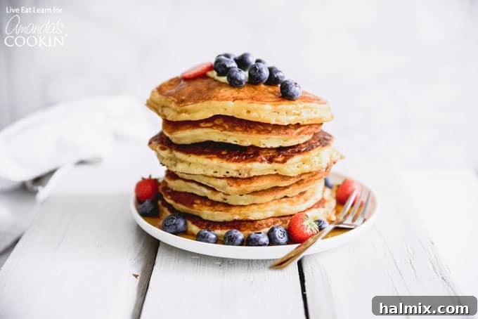 These classic buttermilk pancakes are fluffy, filling, and so delicious. Homemade pancakes are easier than you thought, so throw away that box mix! #breakfast #breakfastrecipes #buttermilkpancakes #pancakes #homemadepancakes A stack of golden brown homemade buttermilk pancakes, ready for toppings and syrup.
