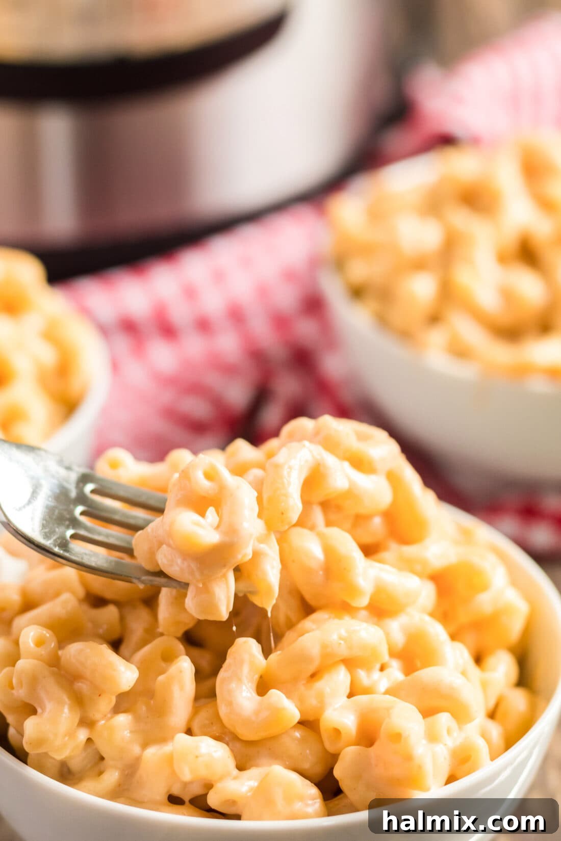 Close-up of a fork in a bowl of creamy Instant Pot Mac and Cheese