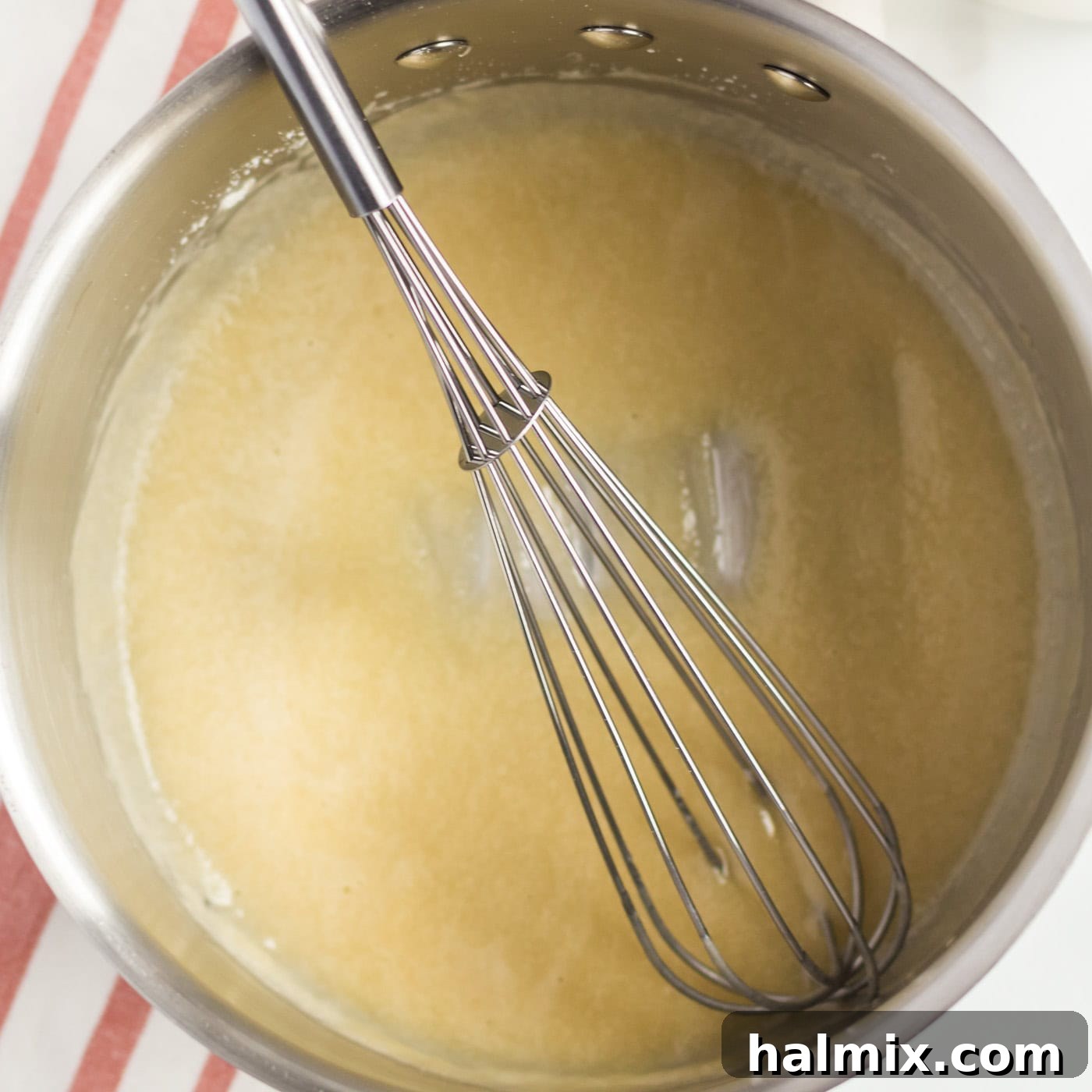 Golden-Crusted Macaroni Bake 4 A saucepan showing butter and flour being whisked together to form a roux.