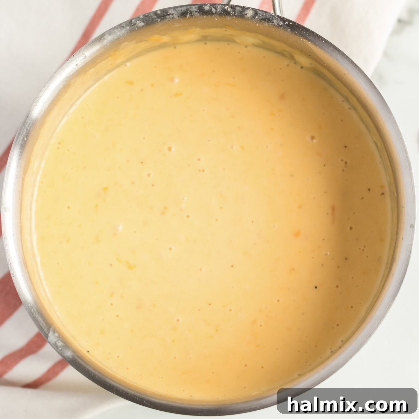 Golden-Crusted Macaroni Bake 7 A saucepan filled with perfectly smooth and creamy cheese sauce, seasoned and ready.