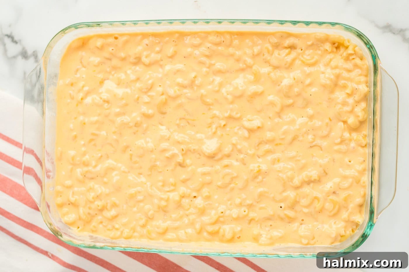 Golden-Crusted Macaroni Bake 8 The creamy cheese sauce poured evenly over cooked macaroni in a 9x13 inch baking pan.