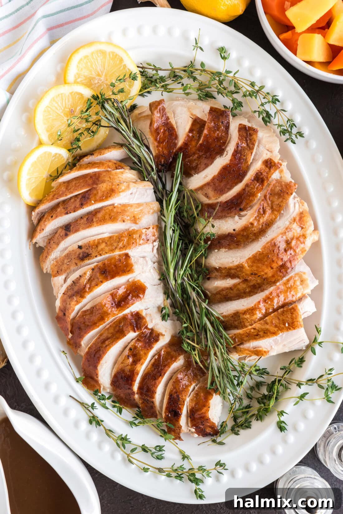 Sliced Roasted Turkey on a white serving platter, ready to be served