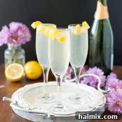 Three French 75 cocktails garnished with lemon twists