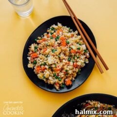 black bowl with cauliflower fried rice and chop sticks