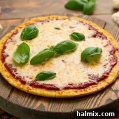 Pizza made with a Cauliflower Pizza Crust on a wooden board