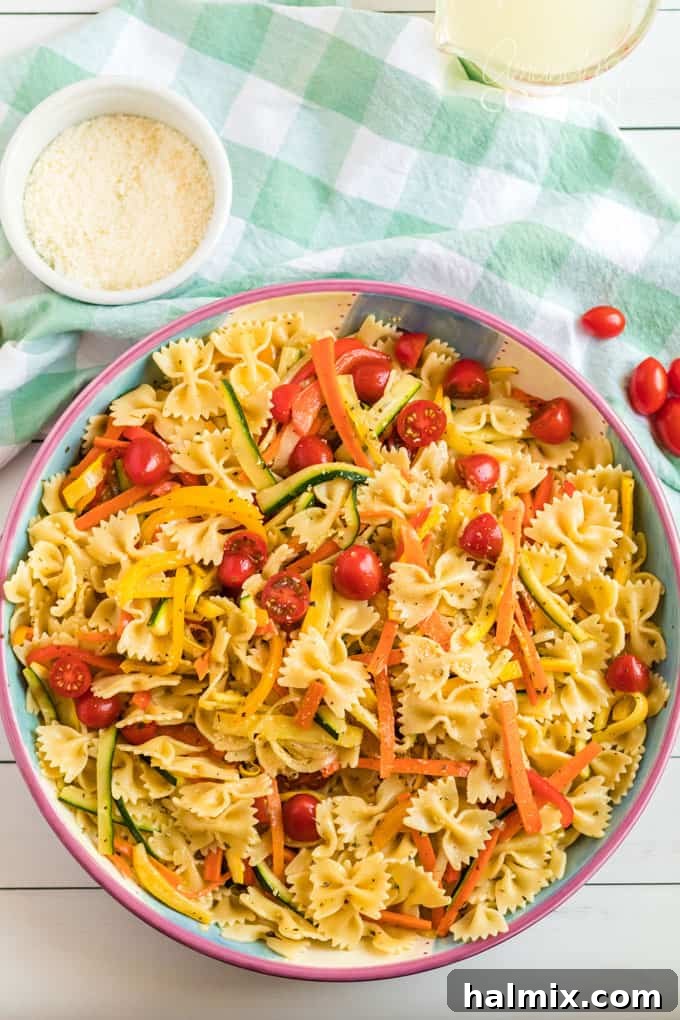 A large, inviting bowl of freshly made Pasta Primavera, brimming with roasted vegetables and pasta, centered on a dining table.