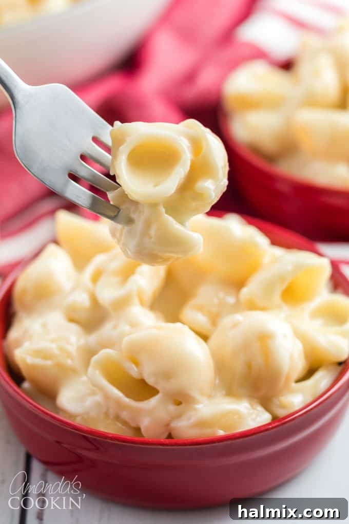 fork full of homemade panera mac and cheese, showcasing its creamy texture