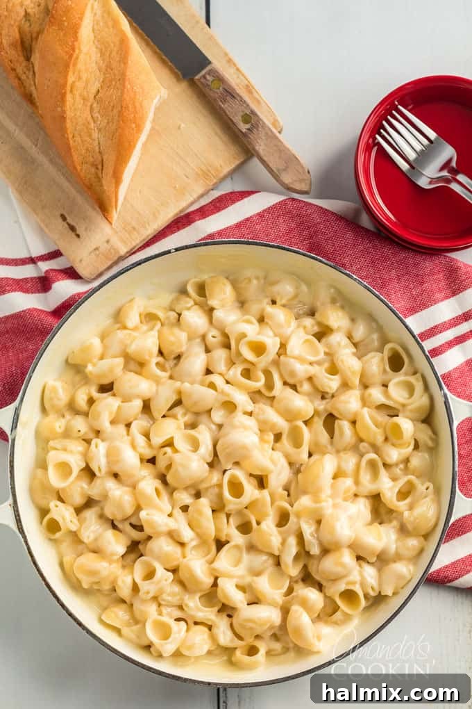 large pot on a stovetop with ingredients for panera mac and cheese recipe, emphasizing cooking process