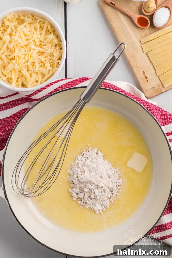 saucepan with melted butter, a whisk, and flour, showing the start of a roux
