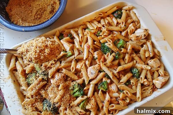 Baked penne pasta with chicken, broccoli, and smoked gouda cheese, a sophisticated take on a classic.