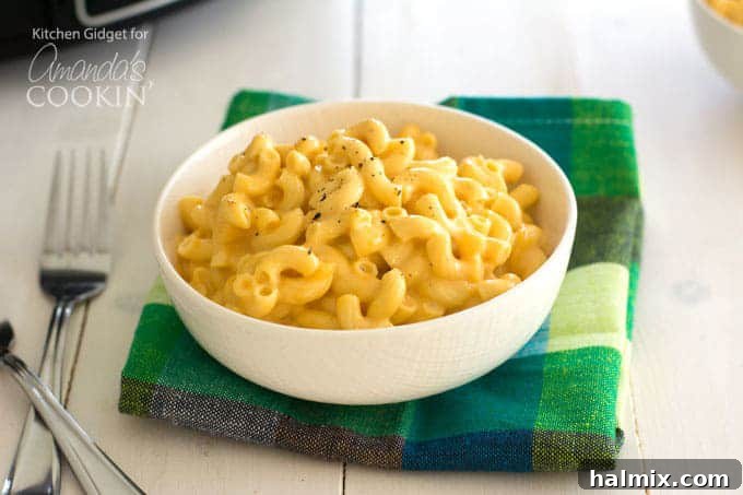 A steaming bowl of Crockpot mac and cheese, rich and creamy, ready to be served.