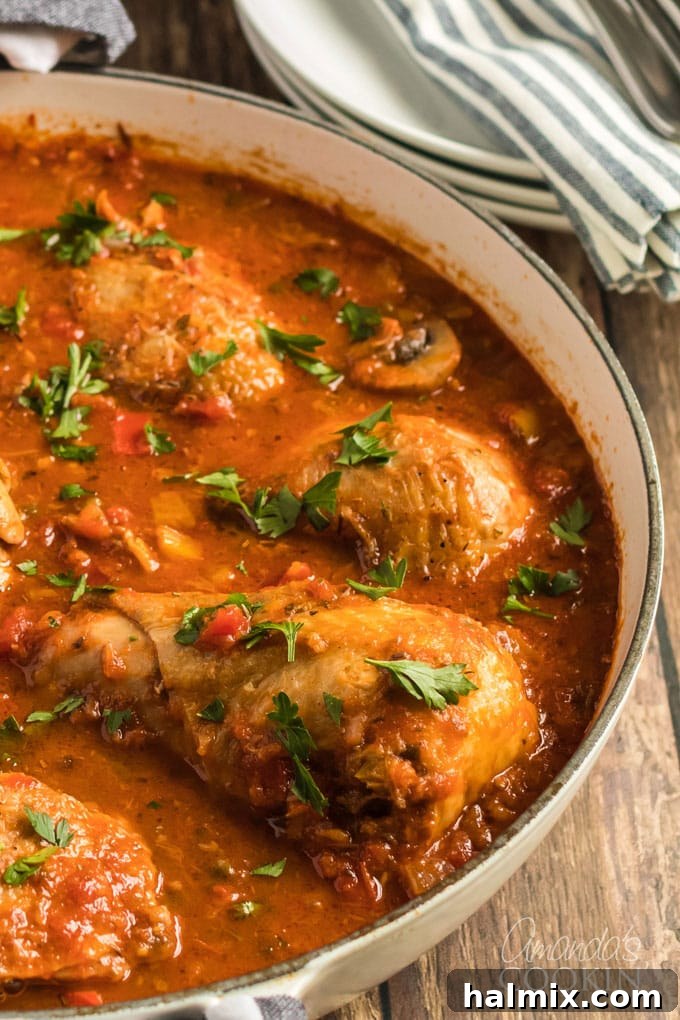 Chicken Cacciatore: a classic Italian stew with chicken, onions, bell peppers, garlic, and capers, cooked slow on the stovetop. Classic Chicken Cacciatore stewed in a large pan, rich with tomatoes, bell peppers, and herbs.