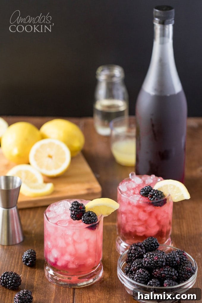 Bramble Bliss 7 Two vibrant Bramble cocktails with fresh blackberries and lemon garnishes, accompanied by a bottle of blackberry liqueur in the background, set for a delightful summer evening.