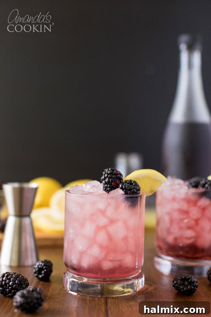 Bramble Bliss 8 A vibrant Bramble cocktail, expertly garnished with a lemon wheel and fresh blackberries, sitting on a table, highlighting its refreshing appeal.