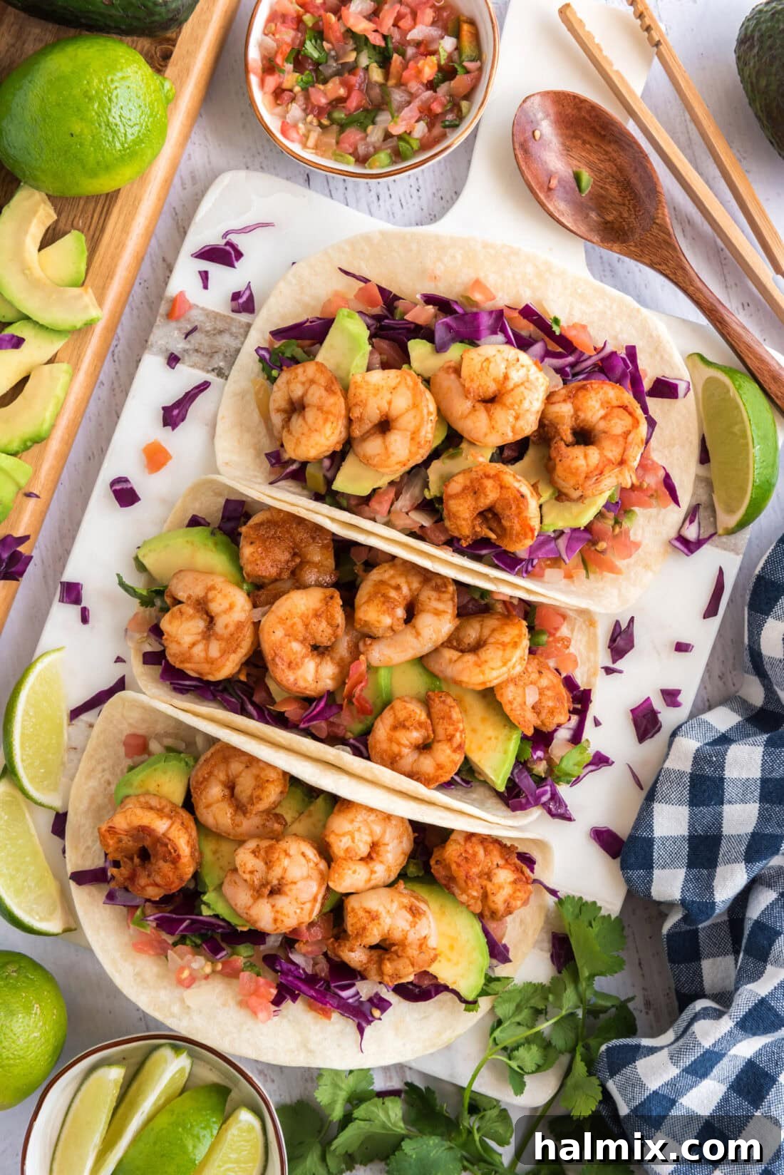 Coastal Shrimp Tacos 2 Three Shrimp Tacos surrounded by limes and pico