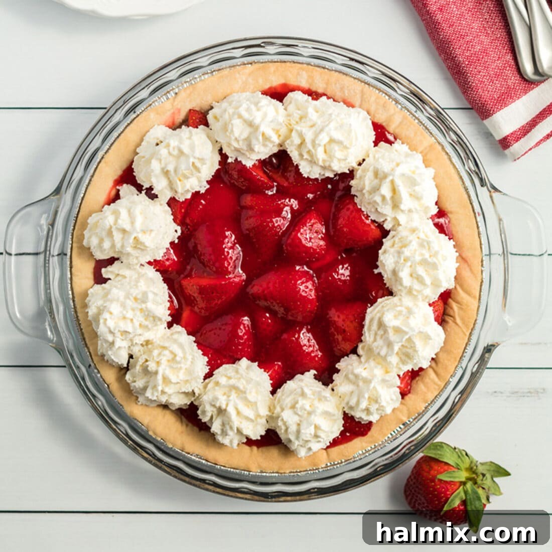 Overhead photo of a freshly made Strawberry Pie, beautifully set and ready to be served, showcasing its vibrant red filling.
