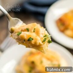 A close-up shot of a fork lifting a perfect bite of creamy, cheesy scalloped potatoes, highlighting the tender layers.