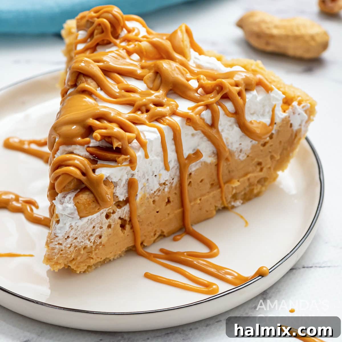 slice of whipped cream topped peanut butter pie