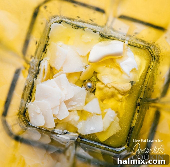 Overhead view of a blender with all the dressing ingredients inside, ready to be blended