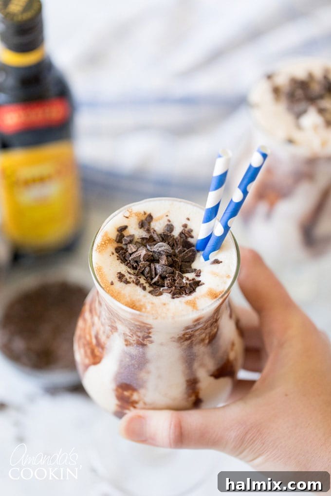 hand holding glass of frozen mudslide