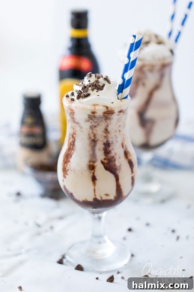 two glasses of frozen mudslides with bottles in background