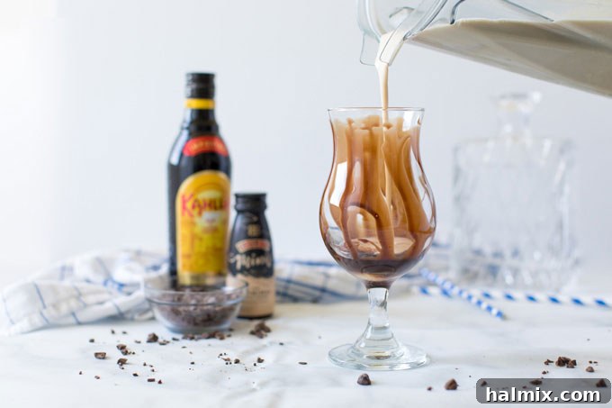 pouring blender contents into chocolate covered glass