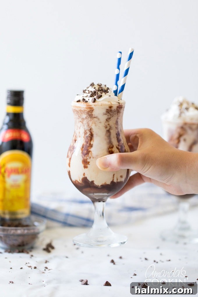 holding glass of frozen mudslide