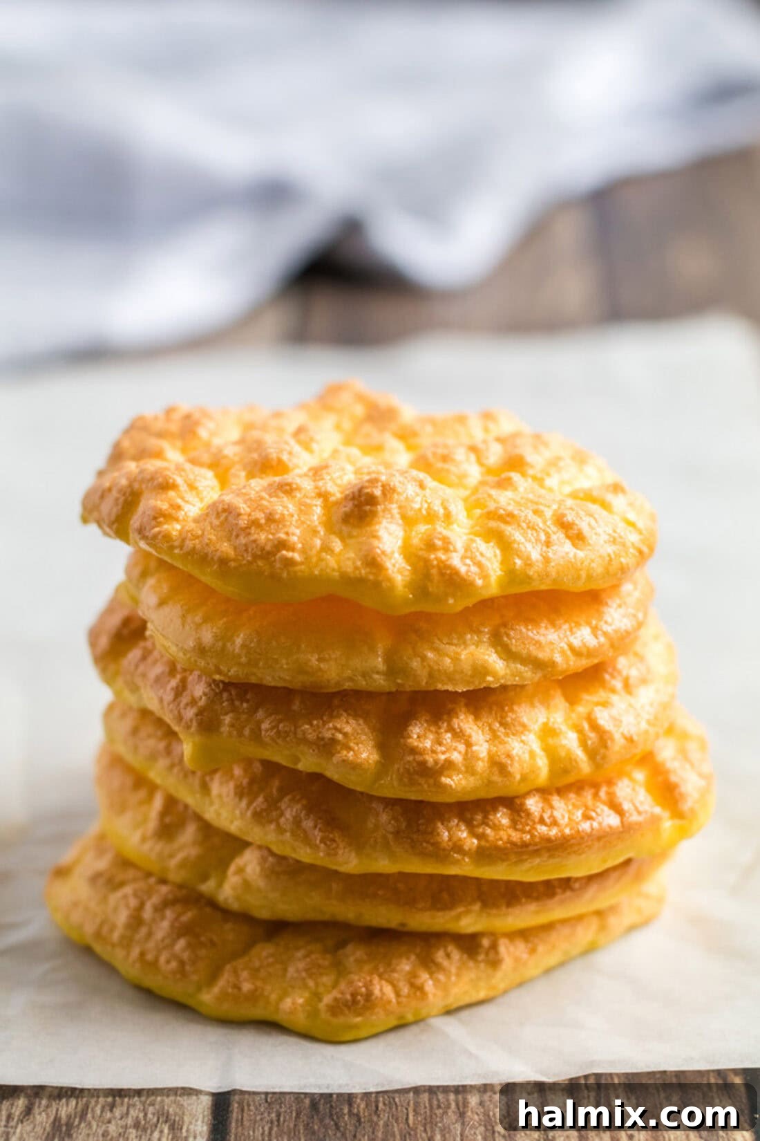 Pillowy Cloud Bread 2 Stack of fluffy, golden-brown cloud bread discs, ready for making sandwiches and wraps