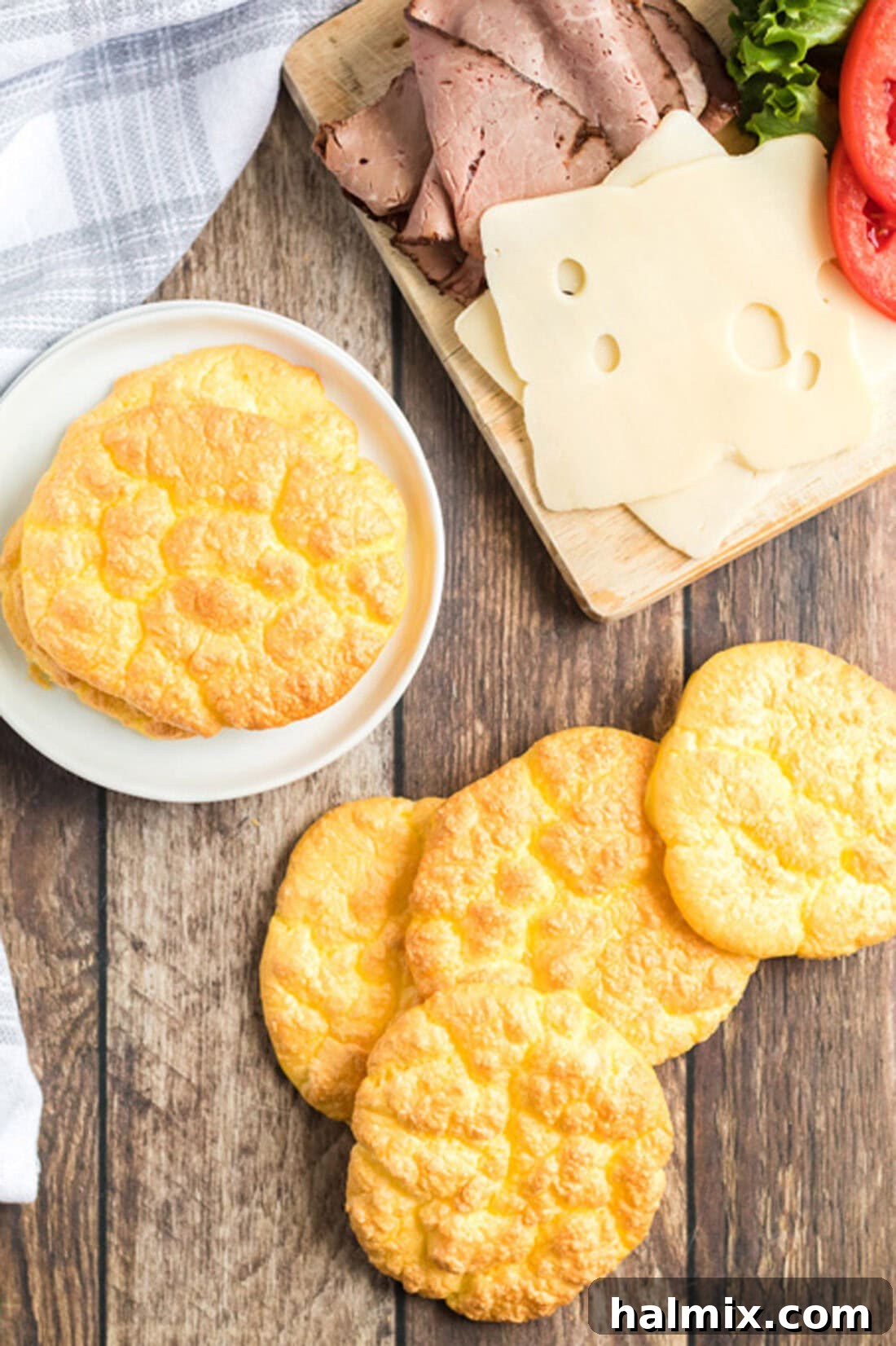 Pillowy Cloud Bread 3 Fluffy cloud bread discs scattered across a rustic wooden table, highlighting their delicate texture