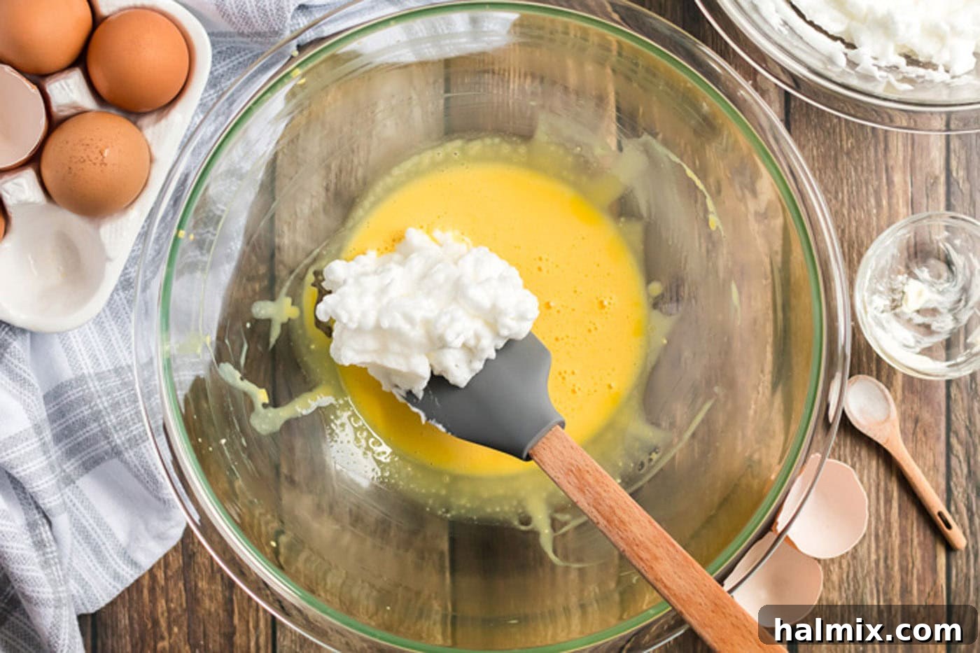 Pillowy Cloud Bread 7 A portion of whipped egg white mixture being gently folded into the egg yolk and cream cheese mixture