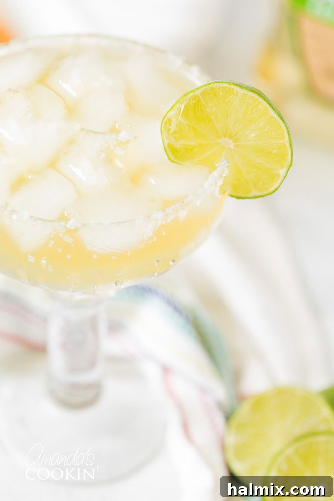 Master the art of making a classic Margarita on the rocks with this easy-to-follow recipe. A quintessential cocktail for any occasion. Classic Margarita on the rocks garnished with a fresh lime wheel, perfect for a sunny day