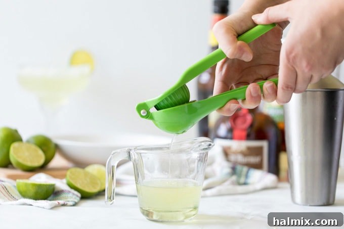 Margarita Magic 2 Squeezing fresh lime juice into a measuring cup, demonstrating the process for a homemade Margarita